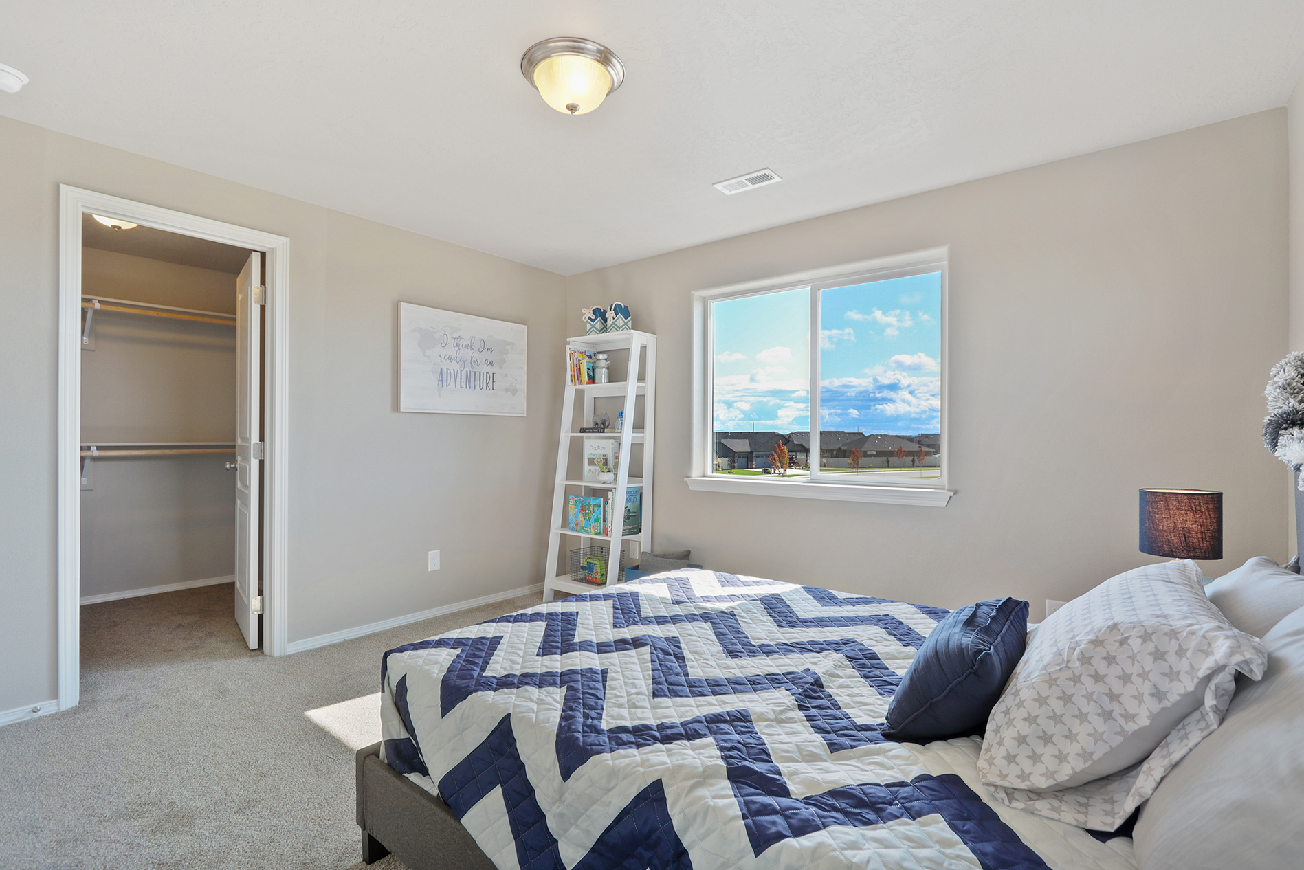 Secondary bedroom with blue chevron comforter in Vale model home. Designing a Kid’s Room that Lasts